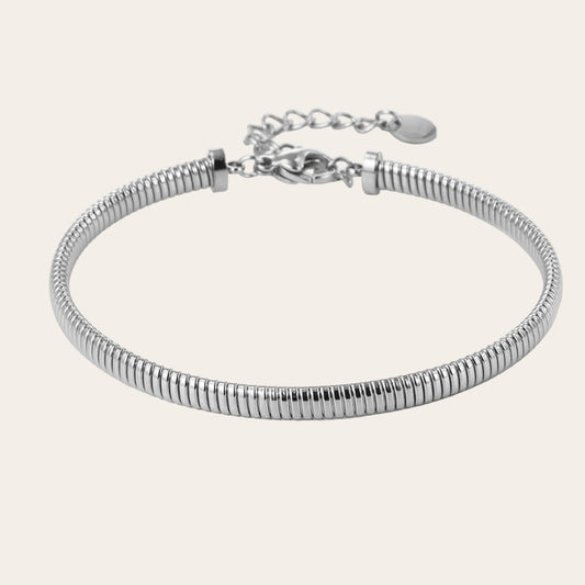 Brazalete fino flexible tipo tubo efecto muelle con cierre y extensión